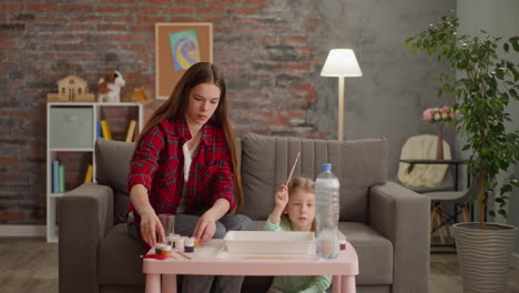 Teenage-girl-prepares-paints-for-Ebru-drawing-with-sister