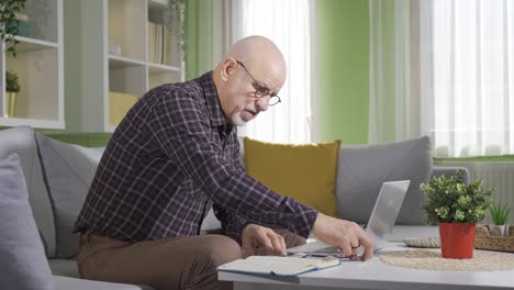 old man calculating spending bills at home.