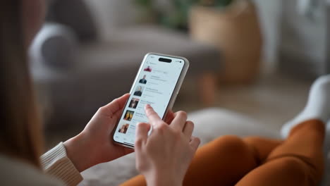 person scrolling through a mobile app on a smartphone