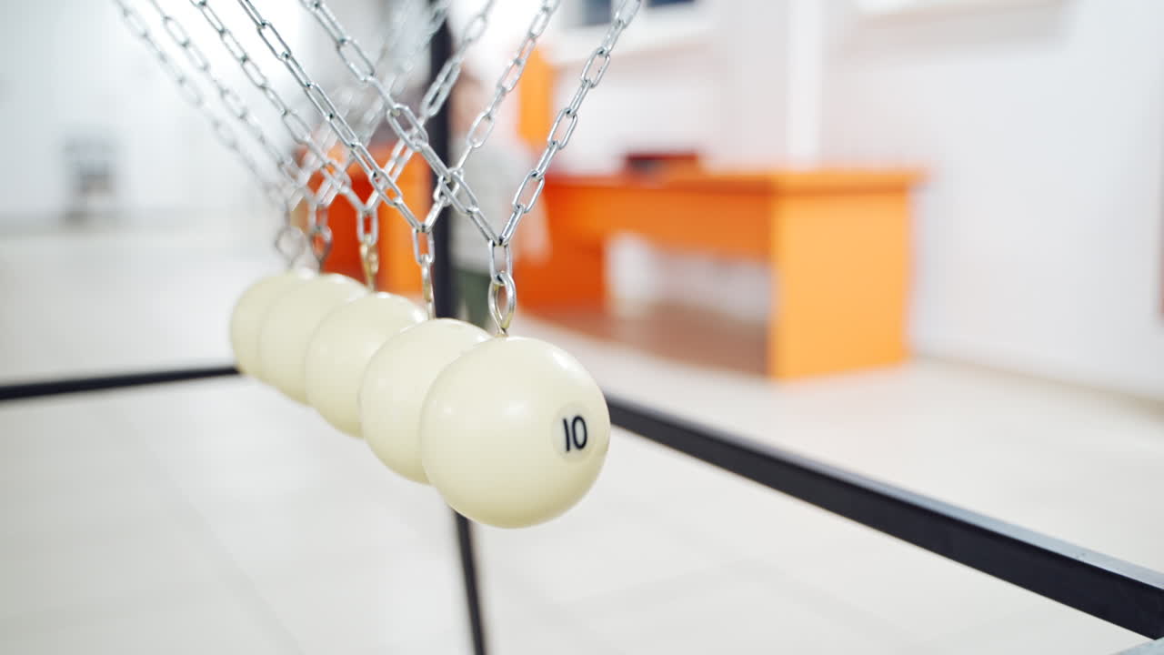 Newton's cradle showing laws of physics in motion. Museum of Science