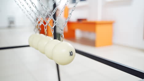 newton's cradle showing laws of physics in motion. museum of science