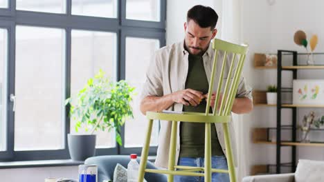 furniture-restoration,-diy-and-home-improvement-concept--man-with-ruler-measuring-old-wooden-chair-for-renovation