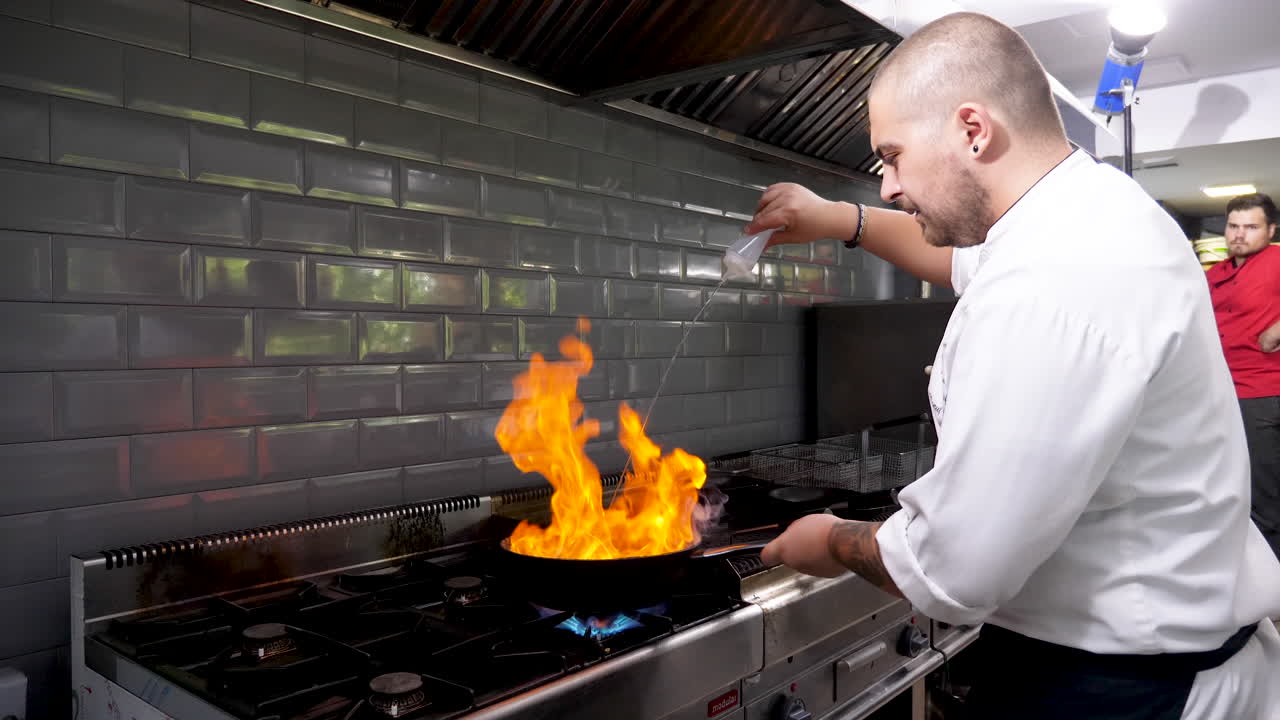 Chef Flambéing Food in a Professional Kitchen