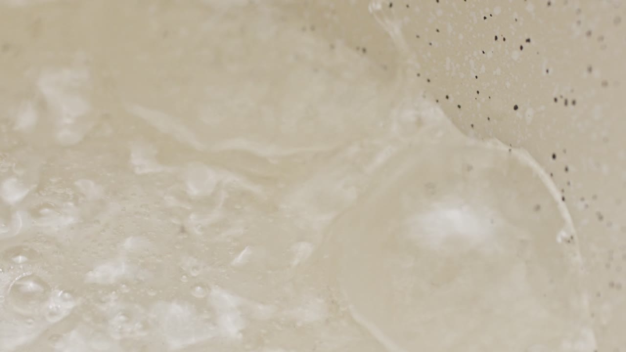 Boiling water in a pan. Macro close up