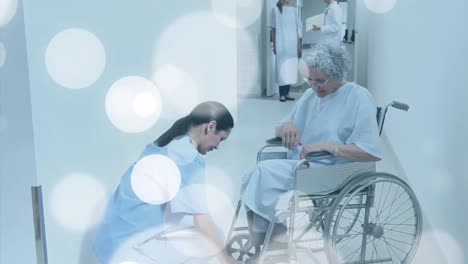 Animación-De-Manchas-Sobre-Enfermera-Caucásica-Con-Paciente-En-Silla-De-Ruedas
