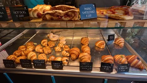 assorted pastries in a glass display case