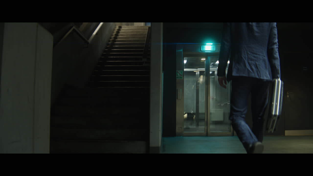 Man walking down a corridor with a rabbit head