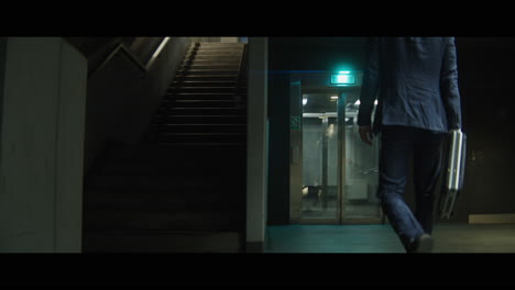 man walking down a corridor with a rabbit head