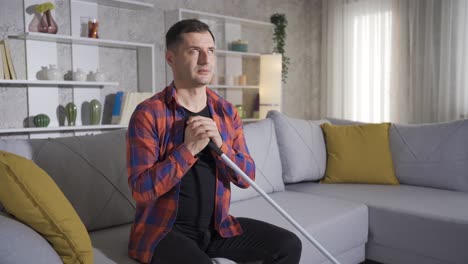 blind man sitting alone at home.