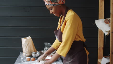 Happy-African-American-Woman-Smiling-at-Camera-and-Kneading-Dough