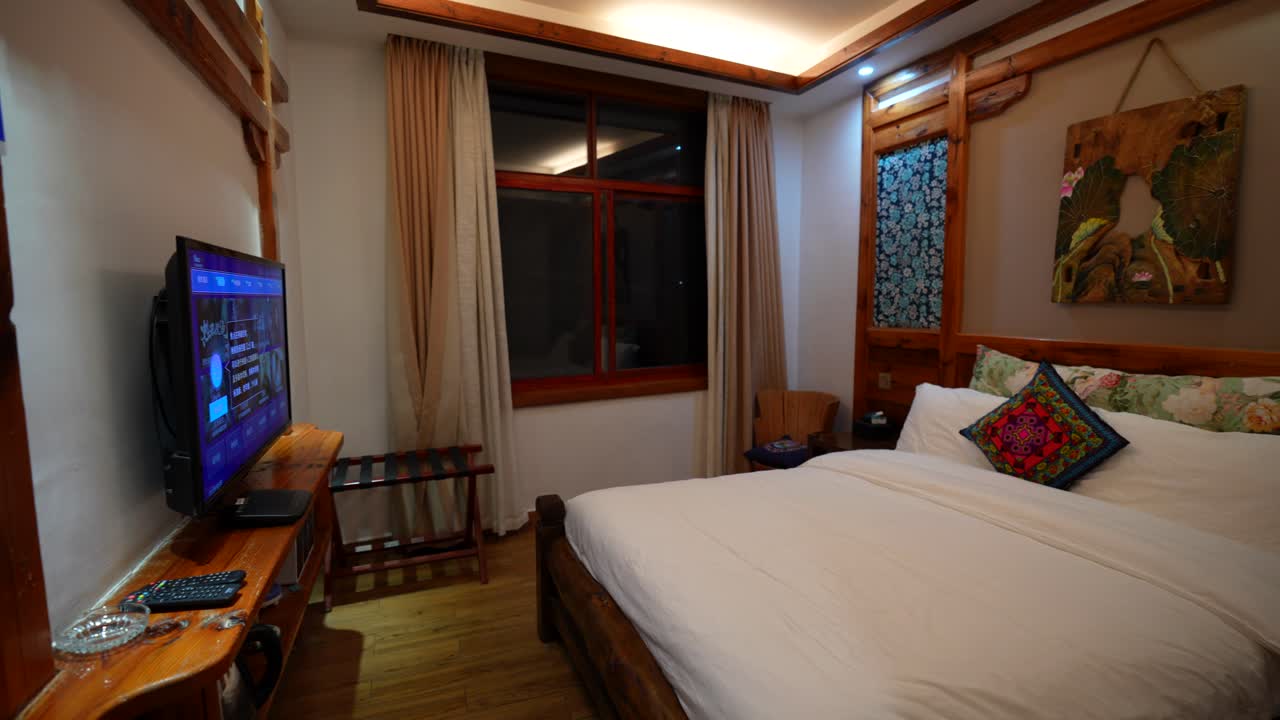 Chinese hotel room with traditional oriental interior decoration. Panning right