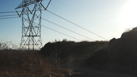 Mountain-biker-jumping-off-a-cliff-at-sunset---golden-hour