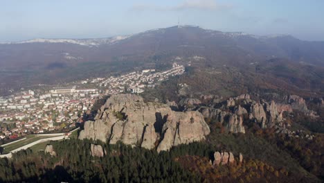 Drone-panning-from-right-to-the-left-of-the-Belogradchik-Cliff,-the-natural-rock-sculptures-situated-west-of-the-town-of-Belogradchik,-in-the-foothills-of-the-western-Balkan-mountain-range