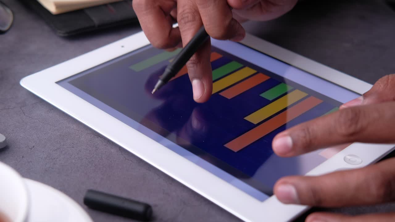 Business Meeting - Analyzing Data on a Tablet