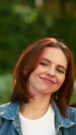 woman with red hair in a park