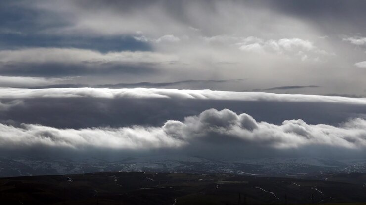 Time Lapse of Dramatic Clouds Moving Over Snowy Mountains