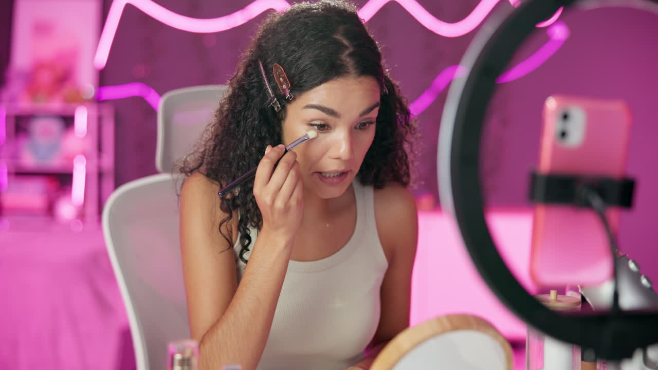Woman applying makeup for beauty vlog
