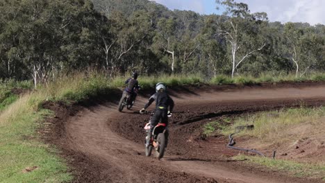 motorcyclist navigating a muddy forest trail