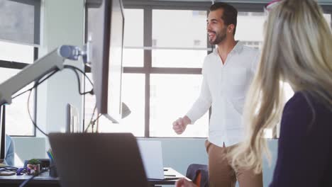 Businessman-celebrating-in-modern-office