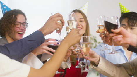 happy multiethnic colleagues toasting with champagne and wine and drinking at the office party 3