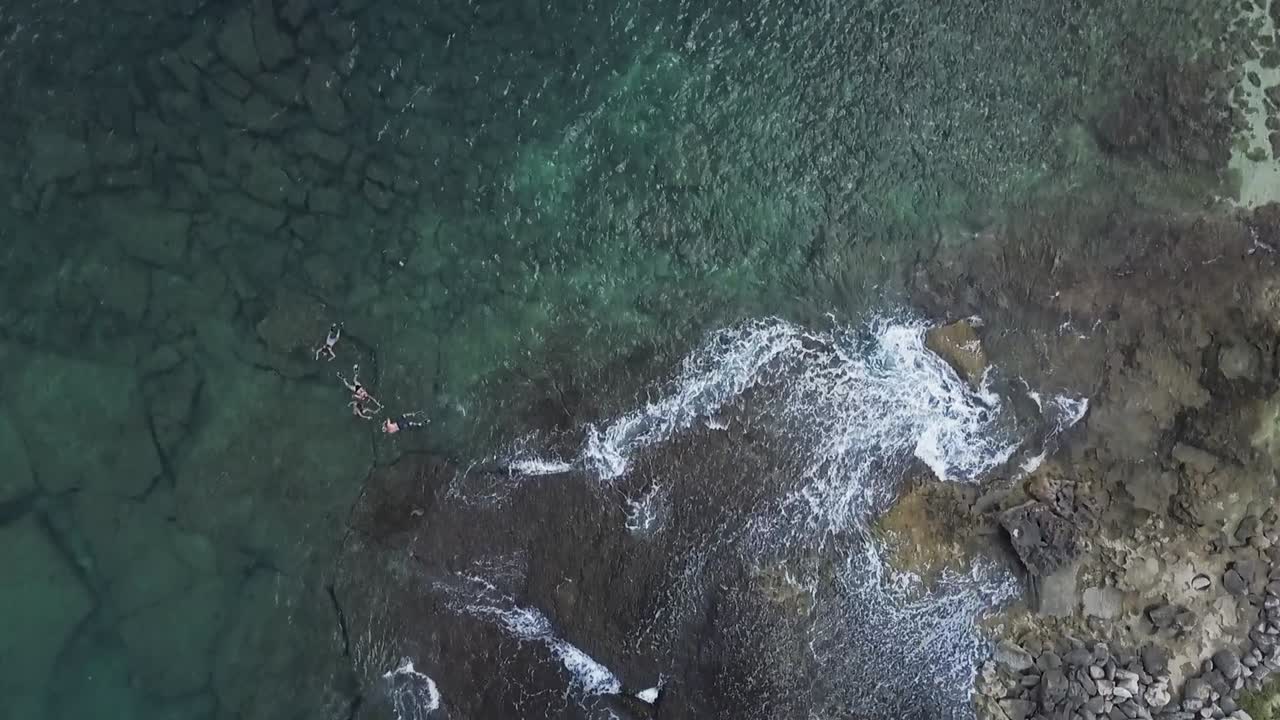 Stunning HD drone footage capturing crystal-clear ocean waters in Hawaii. The vibrant turquoise hues and gentle waves create a breathtaking tropical paradise— ideal travel, nature, and scenic content.
