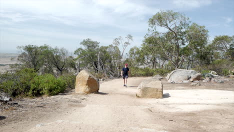 man walking up to the summit of the you yangs national park, victoria australia