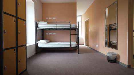 cozy bunk bed in dormitory with locker compartments for shared space