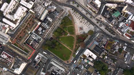 Aerial-rotating-drone-shot-above-Eyre-Square-in-Galway-city-with-seagulls-flying-by