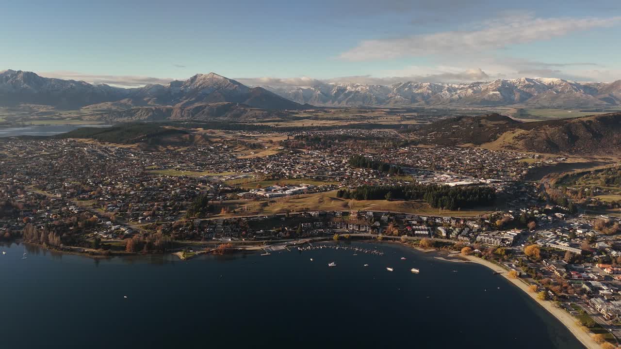 A breathtaking panoramic view of Wanaka town and its tranquil lake at sunset, New Zealand