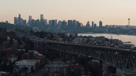 sunset over seattle: aerial view of i-5 freeway traffic, lake union, and city