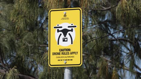 yellow sign indicating drone regulations in effect