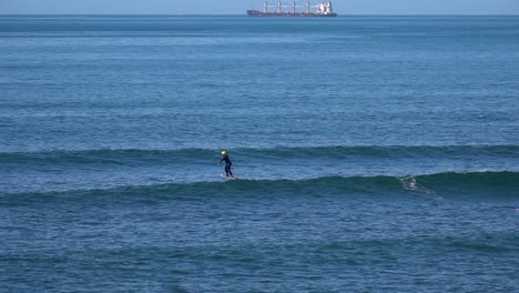 static view of a surfer with his jet surf jumping on the waves. daylight