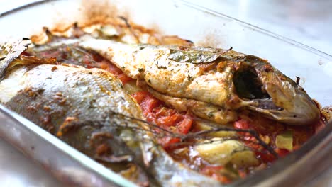 baked sea bream dish with potato and tomato