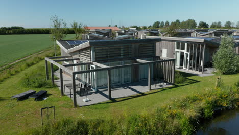 Exterior-View-Of-Bungalow-House-Powered-By-Solar-Panels-In-Roompot-Water-Village-In-Kamperland,-Zeeland,-Netherlands