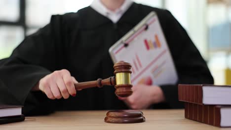 judge or auctioneer with gavel and legal books