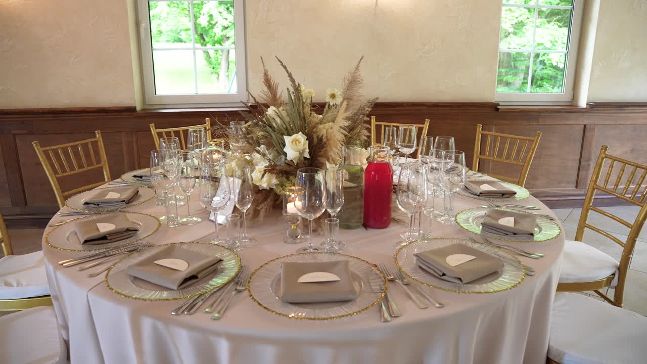 A beautifully arranged table setting with elegant details, featuring silverware, crystal glassware, and a chic floral centerpiece. Perfect ambience for weddings and formal events
