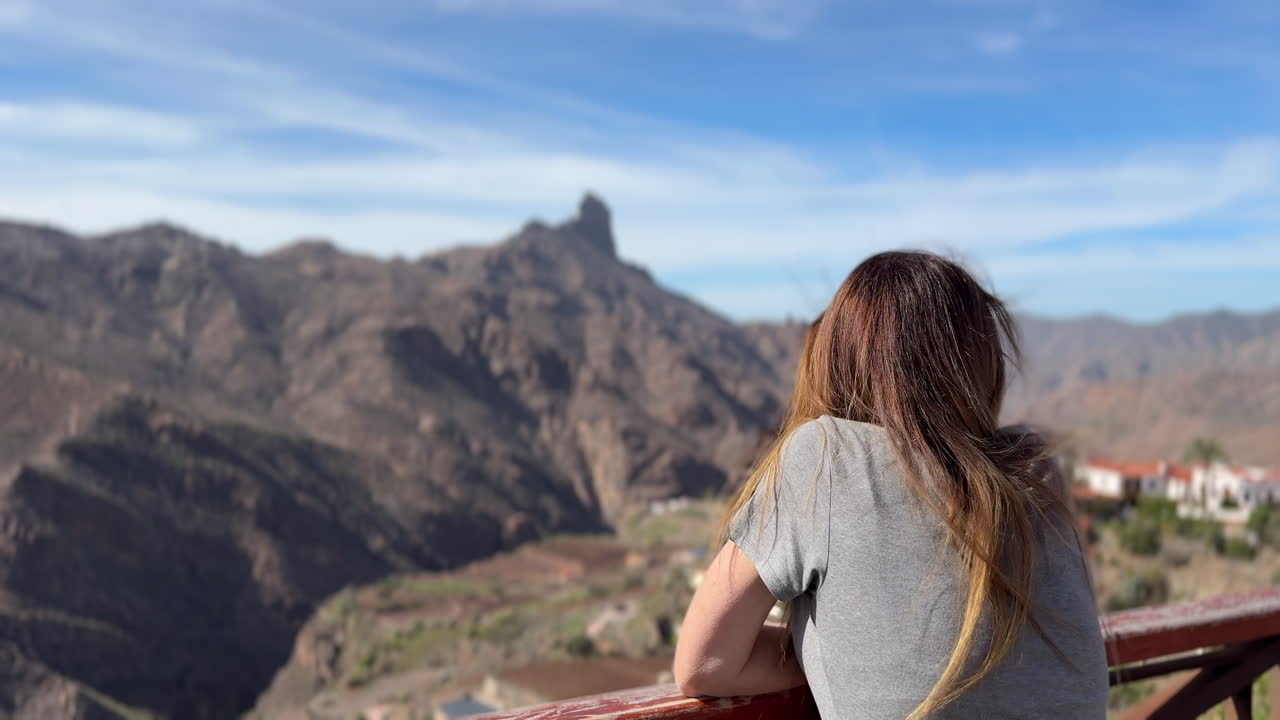 Tourist enjoying breathtaking view of Roque Bentayga from Tejeda in Gran Canaria