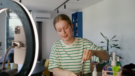 young woman applying makeup in a home setting