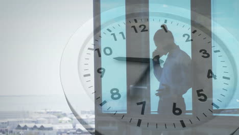 animation of moving clock over asian businessman talking on smartphone in office