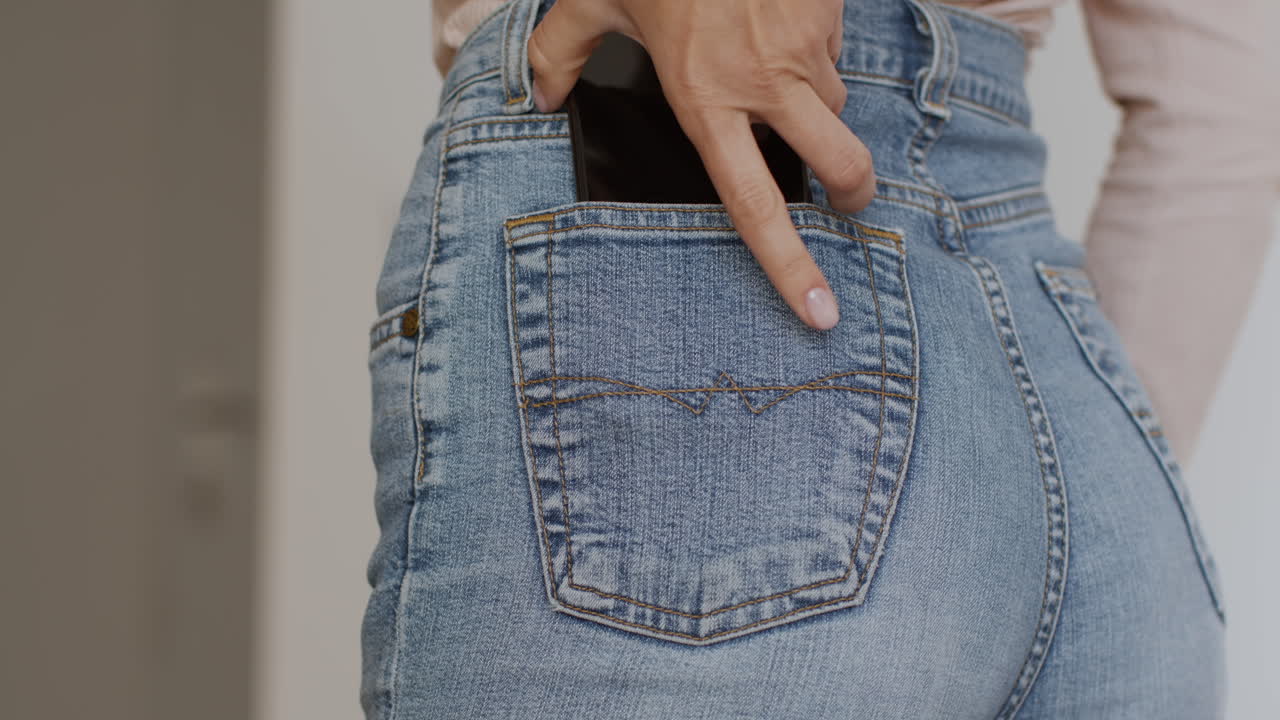 Woman with phone in back pocket