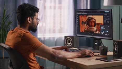 man editing astronaut image on a computer