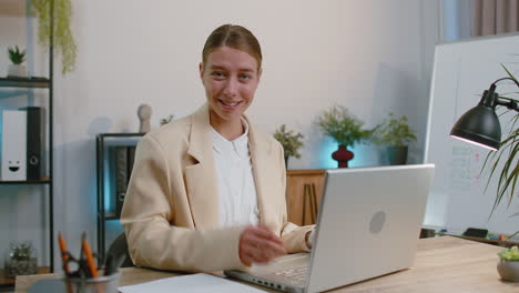 Happy-business-woman-looking-approvingly-at-camera-showing-thumbs-up,-like-positive-sign,-good-news