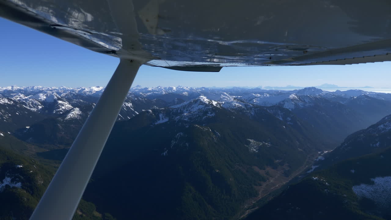 Aerial view of Mountains in Whistler region with snow covered summit and blue sky in summer