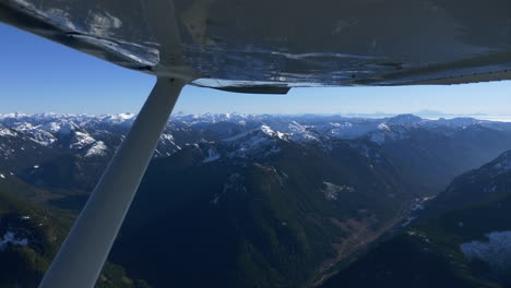 aerial view of mountains in whistler region with snow covered summit and blue sky in summer