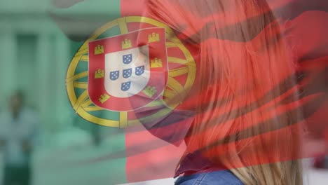 animation of flag of portugal waving over woman wearing face mask during covid 19 pandemic