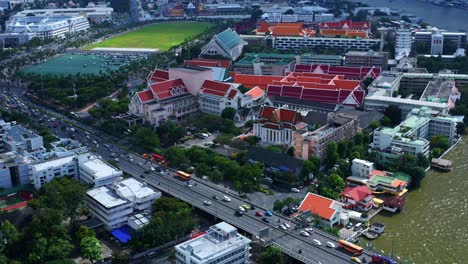 Panoramic-View-of-Bangkok-City,-Thailand-by-the-Rama-VIII-bridge-on-the-Chao-Phraya-River-Aerial