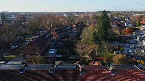 Drone-flying-over-rooftops-and-revealing-a-small-block-of-houses-in-a-peaceful-suburban-neighborhood