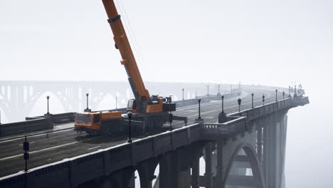 construction crane on an old bridge in fog