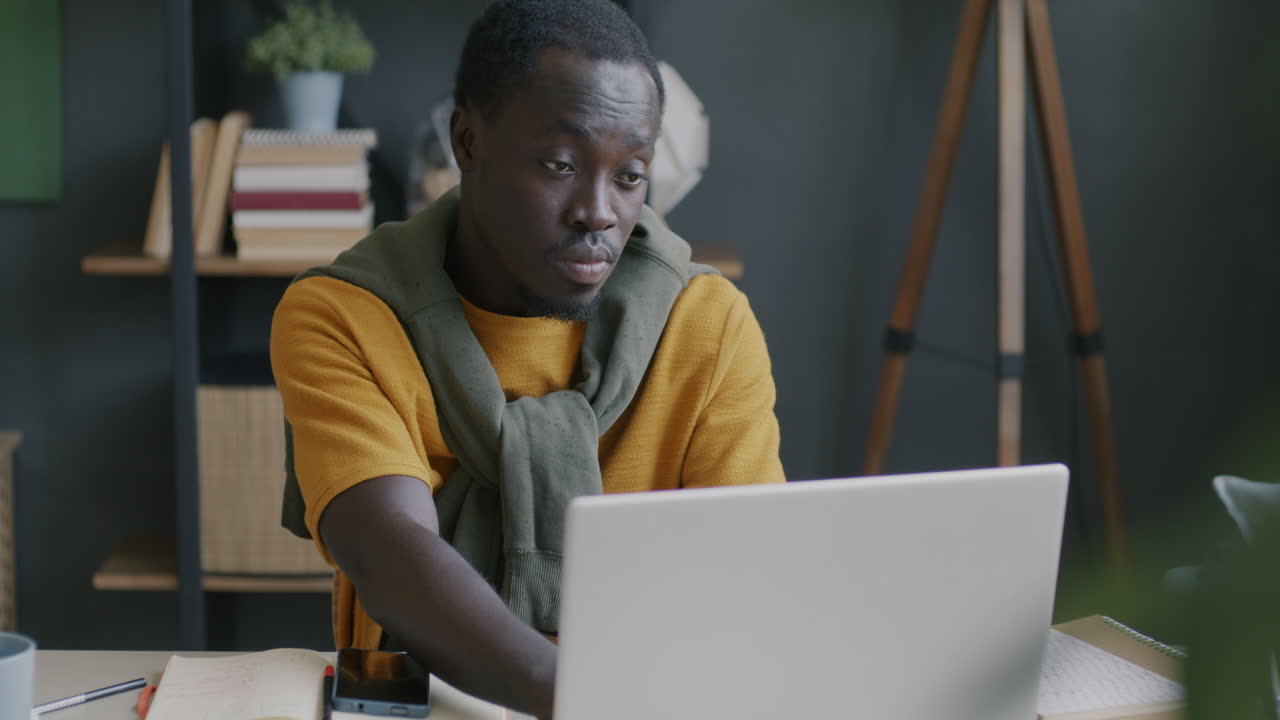 Man working on a laptop in a home office
