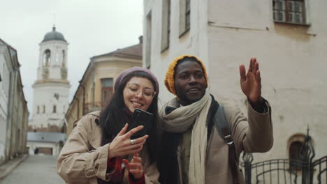 Diverse-Tourist-Couple-Using-Map-on-Phone-and-Discussing-Route